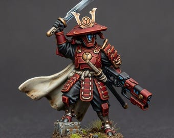 May include: A miniature figurine of a warrior wearing red and gold armor with a helmet featuring a circular emblem. The figure holds a silver sword raised high in one hand and a red and black futuristic rifle in the other, wearing a white cape.