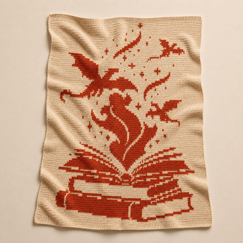 May include: A rectangular crochet blanket in cream with a rust-colored pattern. The design features an open book at the bottom with flames rising from the pages, surrounded by small stars and two flying dragon silhouettes above the flames.