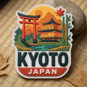 May include: A colorful Kyoto, Japan souvenir magnet. The design features a traditional Japanese temple, a red torii gate, and the text "KYOTO JAPAN". The background includes a sunset, mountains, and bamboo.