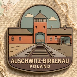 May include: A rectangular patch featuring a stylized illustration of the Auschwitz-Birkenau concentration camp in Poland. The design includes a gatehouse, railway tracks, and the text "AUSCHWITZ-BIRKENAU POLAND" in a brown border.