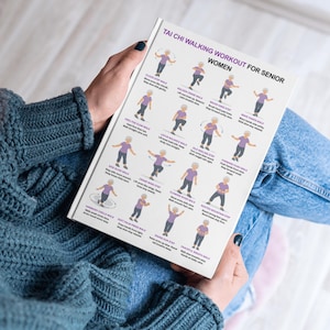 May include: A white notebook with the text "TAI CHI WALKING WORKOUT FOR SENIOR WOMEN" and illustrations of Tai Chi walking exercises. The notebook is held by a person wearing a blue sweater and jeans.