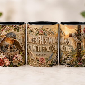 May include: Three ceramic mugs with black rims and handles. The designs feature a bird in a nest with flowers, the text "Under His Wings You Will Find Refuge Psalm 91:4" surrounded by floral patterns, and a cross with a bird and flowers.