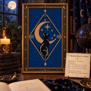 May include: A framed cross-stitch pattern featuring a black cat silhouette sitting inside a golden crescent moon, centred within a diamond-shaped border on a deep blue background. A small card displays the title Mystical Black Cat Moon.