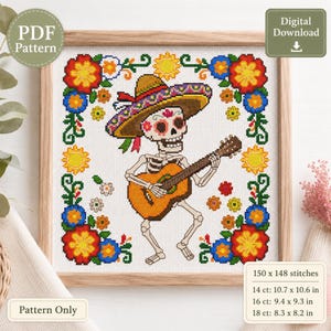 Puede incluir: Patrón de punto de cruz con un esqueleto tocando la guitarra, con un sombrero y rodeado de flores coloridas. El diseño está enmarcado en un marco de madera. El patrón mide 27.2 x 27 cm en tela de 14 hilos.