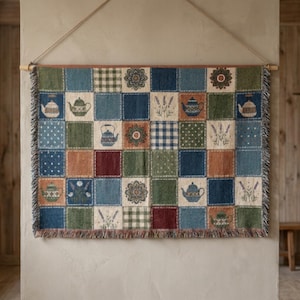 May include: A rectangular woven wall hanging featuring a patchwork grid of squares in shades of blue, green, brown, and cream. The design includes repeating patterns of teapots, floral sprigs, gingham checks, polka dots, and circular motifs.
