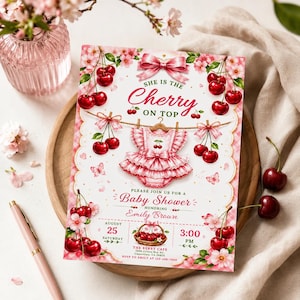 May include: A rectangular baby shower invitation card featuring a pink ruffled baby outfit, red cherries, and pink blossoms. The text reads: She is the Cherry on top, Please join us for a Baby Shower honoring Emily Brown, August 25, 3:00 PM.