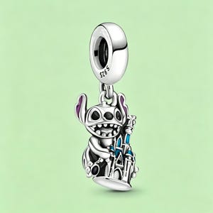 May include: A silver charm featuring the character Stitch from Lilo & Stitch, holding a blue and white castle. The charm has purple accents on Stitch's ears and is suspended from a silver loop.