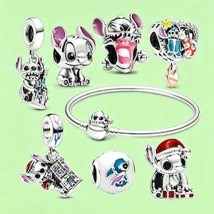 May include: A collection of silver-toned charm beads and a bracelet featuring the character Stitch from Lilo & Stitch. The charms depict Stitch in various poses, some with colorful enamel details, and a bracelet with a clasp featuring Stitch.