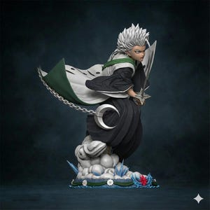May include: A detailed figurine of a character with spiky white hair, wearing a black and white outfit with a green-lined cape. The figure holds a sword and stands on a cloud base with ice and floral accents. A silver chain and crescent moon detail the design.