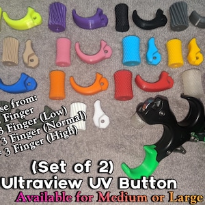 May include: A collection of colorful archery release aids and finger attachments. The image shows various shapes and colors, including yellow, purple, blue, and green. Text on the image reads "Choose from: 2 Finger, 3 Finger (Low), 3 Finger (Normal), 3 Finger (High)".
