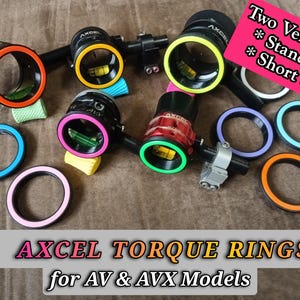 May include: A collection of black and colorful AXCEL torque rings for AV & AVX models. The rings are in various colors, including orange, pink, green, and blue. The image also includes text that says "Two Versions: Standard, Short Shade."