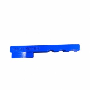 May include: A bright blue, elongated, rigid object with a rectangular base and a handle-like extension featuring three semi-circular cutouts along the top edge. The text RKR 3D PRINTING is embossed on the side of the blue plastic component.