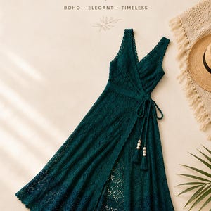 May include: A dark teal crochet maxi dress with a V-neckline and a wrap design. The dress features a tie waist with tassel and bead details. The text "CROCHET MAXI DRESS" is at the top of the image, with "BOHO • ELEGANT • TIMELESS" below.