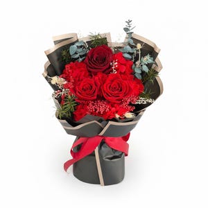 Puede incluir: Un ramo de rosas rojas y otras flores rojas, envuelto en papel negro con ribete dorado. El ramo est&aacute; atado con una cinta roja. La vegetaci&oacute;n y peque&ntilde;as flores blancas se intercalan en el arreglo.