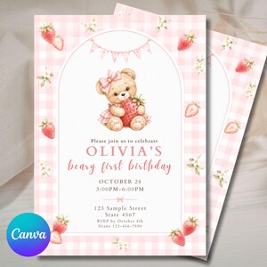 May include: A rectangular birthday invitation card featuring a light pink gingham border with strawberry and flower illustrations. A teddy bear wearing a pink bow and dress holds a strawberry. Text reads: Please join us to celebrate OLIVIA'S beary first birthday OCTOBER 28 3:00PM-6:00PM 123 Sample Street State 4567 RSVP by October 8th Diane 123-456-7890.