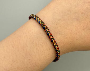 Bracciale tibetano intrecciato a mano: nodo portafortuna, gioiello per la guarigione spirituale e la meditazione.