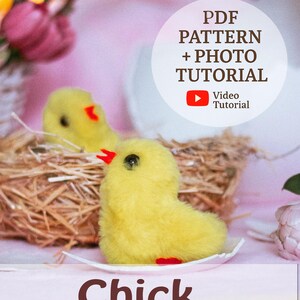 May include: A fluffy yellow chick with a red beak sits on a small white plate. The chick is part of a craft project, with a nest of straw in the background. The image includes text that says "PDF Pattern + Photo Tutorial" and "Chick".