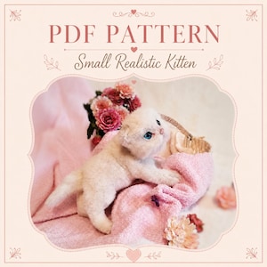 May include: A PDF pattern titled "Small Realistic Kitten" featuring a light-colored, plush kitten with bright blue eyes resting on a soft pink towel. The image includes decorative floral accents and a light pink border with ornate corner details.