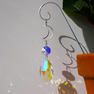 Op de afbeelding: Een witte keramische mok met een zwart handvat en de tekst "But First, Coffee" in een vetgedrukte, zwarte letter. De mok staat op een houten oppervlak. De mok is ongeveer 10 cm hoog.