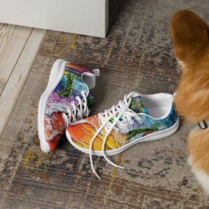 May include: A pair of low-top sneakers featuring a vibrant, multi-colored abstract print with swirling patterns of orange, yellow, blue, and purple. The shoes have white laces, white interior lining, and white soles, with a green panther graphic.