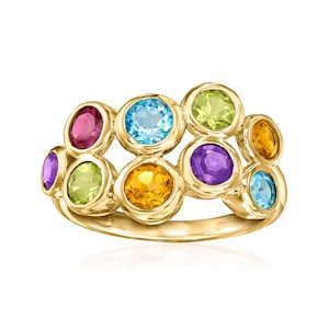 May include: A gold ring featuring a cluster of colorful gemstones. The ring showcases a variety of round-cut stones in shades of pink, blue, yellow, green, and purple. The gemstones are set in individual bezels, creating a vibrant and eye-catching design.