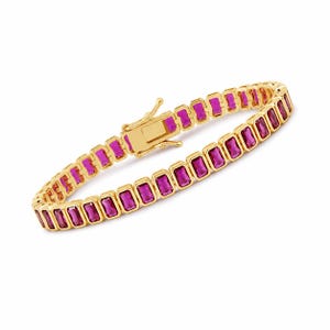 May include: A gold-colored bracelet featuring rectangular, magenta-colored gemstones. The bracelet has a secure clasp and is designed with a repeating pattern of gemstones set in a gold frame. The jewelry is displayed against a white background.