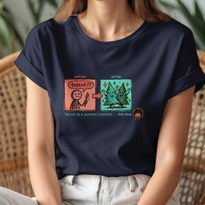 A streetwear-style t-shirt featuring a Y2K cyber-graphic with a portrait of Bob Ross and the quote "Talent is a pursued interest" in bold typography.