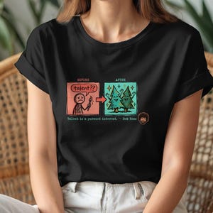 A streetwear-style t-shirt featuring a Y2K cyber-graphic with a portrait of Bob Ross and the quote "Talent is a pursued interest" in bold typography.