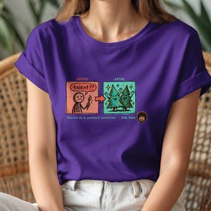 A streetwear-style t-shirt featuring a Y2K cyber-graphic with a portrait of Bob Ross and the quote "Talent is a pursued interest" in bold typography.