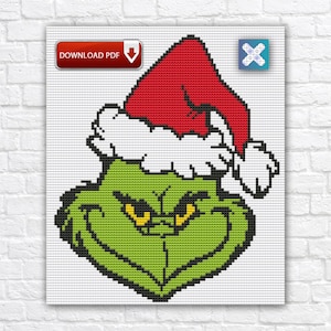 May include: Cross-stitch pattern featuring a green character with a red Santa hat and white trim. The character has yellow eyes and a grumpy expression. The words "DOWNLOAD PDF" are in a red box in the upper left corner.
