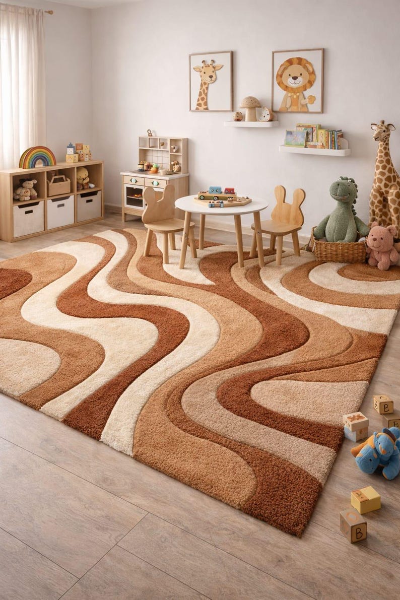 May include: A plush, wavy-patterned area rug in shades of brown, beige, and cream dominates a child's playroom. The rug's design complements the room's wooden furniture, toys, and animal-themed artwork. The room includes a small table and chairs.