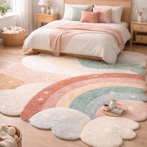 May include: A colorful, cloud-shaped rug with a rainbow design in a bedroom setting. The rug features pastel colors like pink, blue, and beige. The bedroom has a bed with pillows and a wooden frame.