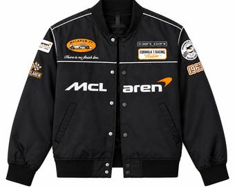 May include: A black bomber jacket featuring white and orange McLaren branding, Formula 1 racing patches, and the text 'There is no finish line' on the chest. The jacket includes a snap-button front closure, ribbed cuffs, and a collar with white piping.