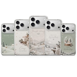 May include: Five clear smartphone cases featuring winter-themed illustrations. Designs include a snowy landscape with a deer, a mug of cocoa with the text Cozy Winter, a river scene with Peaceful Holiday, a snowy bench with Merry Little Winter, and a snow globe with Happy Winter Days.