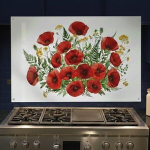 May include: A kitchen backsplash featuring a watercolor painting of red poppies, yellow wildflowers, and green ferns. The artwork is mounted above a stainless steel gas range. The kitchen has dark blue cabinets and a white ceramic jar.