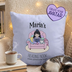 May include: A light purple square throw pillow featuring a cartoon illustration of a person reading a book in a pink armchair with a cat. The text reads Maria's READING NOOK where adventures begin. A purple heart sticker says CREATE YOUR AVATAR.