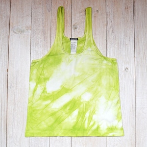 May include: A green and white tie-dye tank top with a scoop neck.