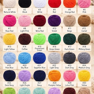 May include: A color chart displaying 39 numbered balls of yarn in various shades, including white, black, red, pink, blue, green, and brown. The text YARN COLORS appears at the top, and Font Selection 1-4 is listed at the bottom right.