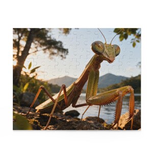 May include: A jigsaw puzzle featuring a detailed image of a praying mantis. The insect is green and brown, with large eyes and spiky legs, set against a natural outdoor scene with a lake and mountains.