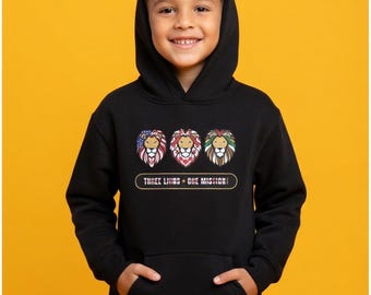 May include: Black hooded sweatshirt featuring three lion head designs with patriotic color schemes. The text "THREE LIONS + ONE MISSION" is printed below the lion graphics. The sweatshirt has a front pocket and a hood.