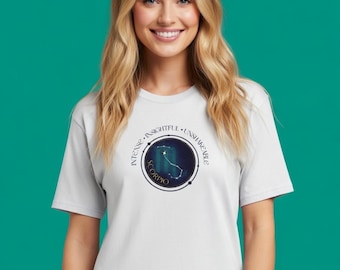 May include: A white t-shirt featuring a circular graphic with the word "SCORPIO" and a constellation design. The graphic is surrounded by the words "INTENSE", "INSIGHTFUL", and "UNSHAKABLE".