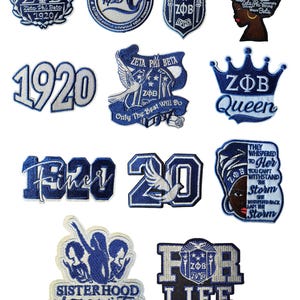May include: A collection of blue and white embroidered patches featuring the letters ZΦB, the Greek letters for Zeta Phi Beta Sorority, Inc. Designs include the year 1920, doves, crowns, and the words "Sisterhood" and "For Life."