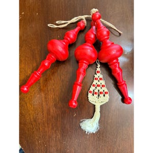 May include: A white ceramic mug with a black handle and the text "But First, Coffee" in a black, handwritten-style font. The mug is on a white surface.