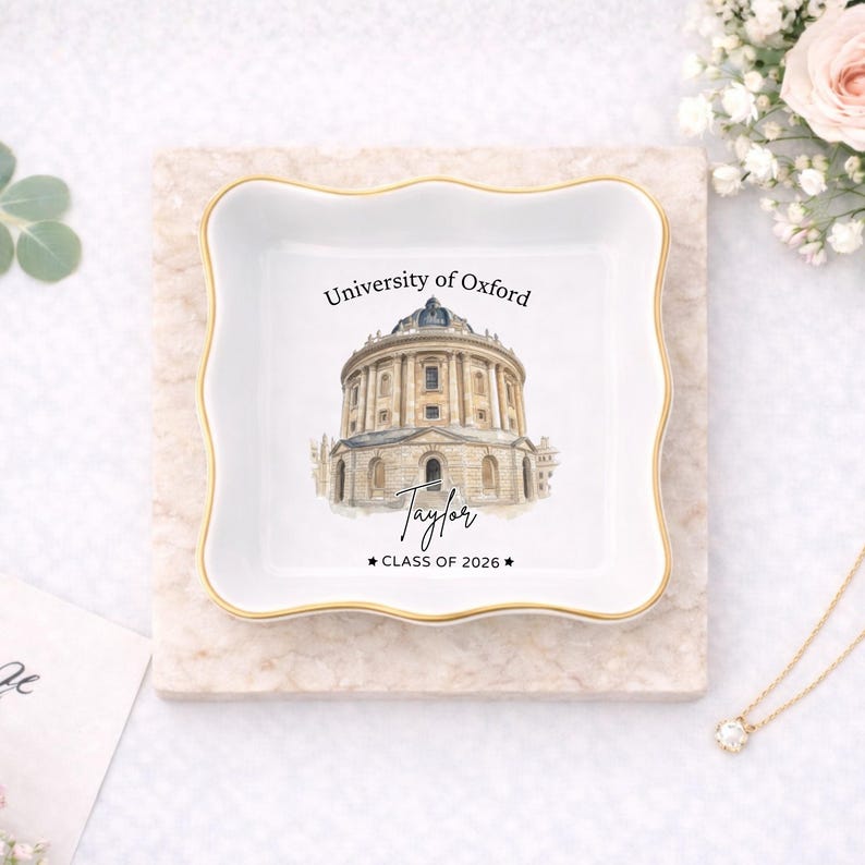 May include: A white square trinket dish with a gold rim, featuring a watercolor illustration of the University of Oxford's Radcliffe Camera. The dish is personalized with the name "Taylor" and "CLASS OF 2026".