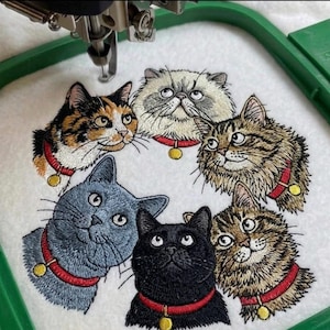 May include: Embroidered design of six cat portraits, each with unique fur patterns and expressions. The cats wear red collars with gold pendants. The design is on white fabric, with a green embroidery hoop visible.