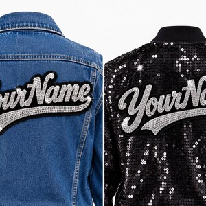 May include: A blue denim jacket and a black sequin jacket, both featuring a large, arched patch on the back with the text YourName in silver, sparkling rhinestones. The text is written in a cursive script font with a black felt border.