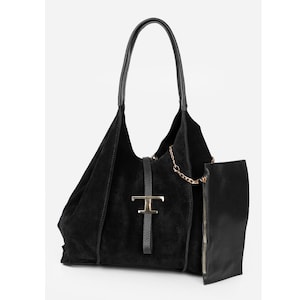 May include: Black suede tote bag with a leather handle and a gold-tone metal clasp. The bag features a detachable pouch with a zipper closure and a gold chain detail. A stylish and functional accessory.