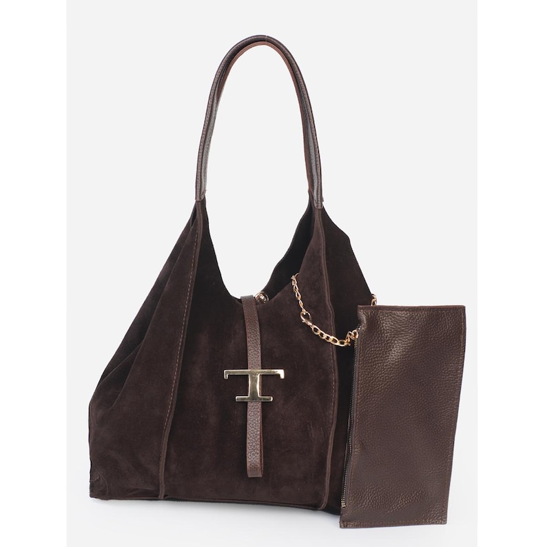 May include: A dark brown suede shoulder bag with a matching leather handle and a detachable pouch. The bag features a gold-tone metal clasp and a gold chain detail. The bag is a stylish accessory.