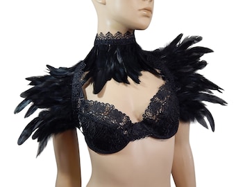 May include: Black feather shoulder piece with a matching lace choker. The shoulder piece is made of black feathers and has a lace trim. The choker is also made of black lace and has a feather trim.