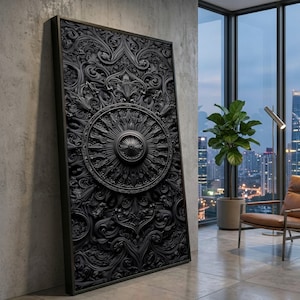 May include: A large, black, rectangular wall art piece with intricate, raised floral and geometric patterns. The artwork features a central circular design with radiating lines and a prominent center. The piece is framed in a dark, rectangular border.